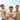Three people holding coffee cups with a blurred outdoor background