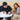 Man and woman sitting at a table with a dog, enjoying food and drinks.